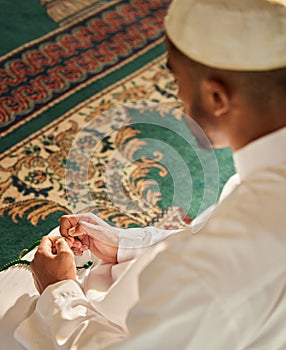 Muslim, prayer and man in mosque with tasbih in hands for spiritual worship of God in temple. Person, praying and photo