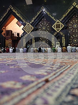 Muslim, prayer and mosque with a spiritual man group praying together during fajr, dhuhr or asr, otherwise maghrib or ishaa