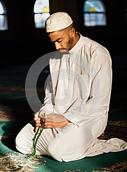 Muslim, praying and spiritual man in mosque for worship of God, Allah and mindfulness in temple. Tasbih, prayer and photo