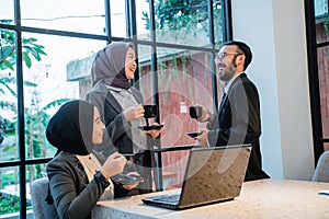 muslim team having conversation during meeting at the office