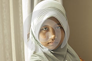 Muslim teenage girl looking at camera