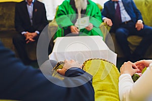 Muslim wedding rite. Bride and groom sitting on the floor in the moqsue. Muslim Wedding prayers. Nikah.