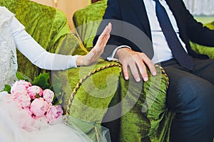 Muslim wedding rite. Bride and groom sitting on the floor in the moqsue. Muslim Wedding prayers. Nikah.