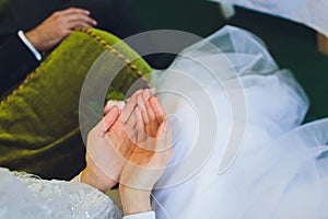 Muslim wedding rite. Bride and groom sitting on the floor in the moqsue. Muslim Wedding prayers. Nikah.