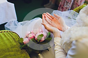 Muslim wedding rite. Bride and groom sitting on the floor in the moqsue. Muslim Wedding prayers. Nikah.