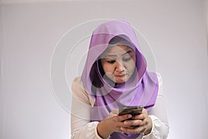 Muslim Woman Angry While Reading Text Message on Smart Phone