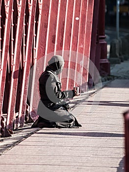 Muslim woman asking for alms