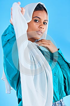 Muslim woman, beauty and portrait of hijab in studio, blue background or color backdrop. Young female model, islamic