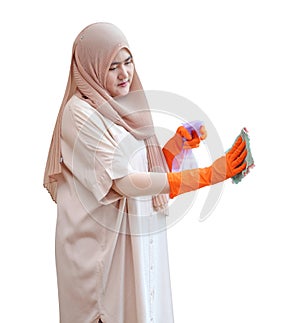 Muslim woman cleaning door glass with fabric and alcohol spray on white background