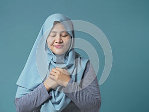 Muslim Woman Close Her Eyes, Hands on Heart and Pray