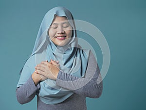 Muslim Woman Close Her Eyes, Hands on Heart and Pray