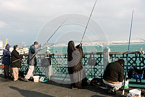 Muslim woman fishing at evening