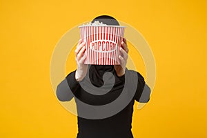 Muslim woman in hijab black clothes 3d imax glasses watch movie film hold popcorn, hiding face pop corn isolated on