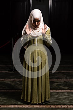 Muslim Woman in Hijab Praying on Mat