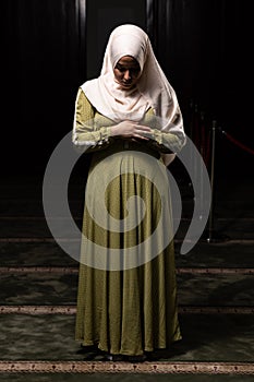 Muslim Woman in Hijab Praying on Mat