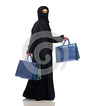 Muslim woman in hijab with shopping bags