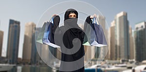 Muslim woman in hijab with shopping bags in dubai