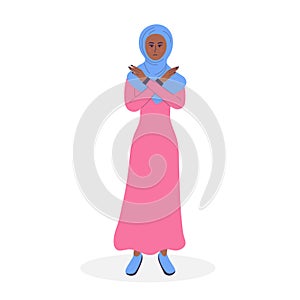 Muslim woman in hijab showing refusal or stop gesture with crossed hands.