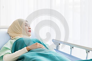 Muslim woman patient on bed