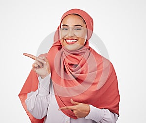 Muslim, woman and pointing, advertising and presentation with smile in portrait isolated on white background. Business