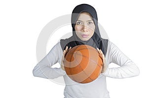 Muslim woman posing with a basketball