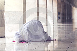 Muslim woman posing prostration in the mosque