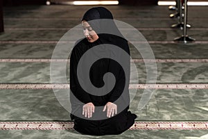 Muslim Woman Praying at the Mosque