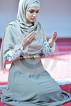 Muslim woman praying in mosque