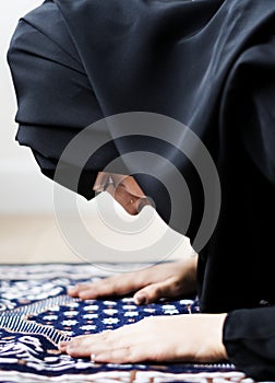 Muslim woman praying in the mosque during the Ramadan