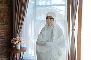 Muslim woman praying wearing hijab