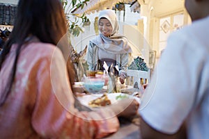 Muslim woman preparing dining table for breaking the fast