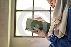 Muslim woman reading from the Quran