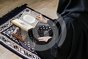 Muslim woman reading from the quran