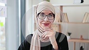 Muslim woman in scarf posing in office interior
