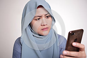 Muslim Woman Seriously Looking at Phone