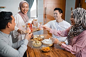 muslim woman serving drink for friend and family after fasting