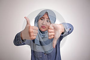 Muslim woman shows thumbs up and down gesture