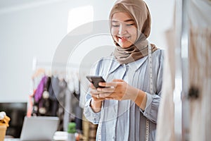 muslim woman small business owner at her shop selling through e commerce