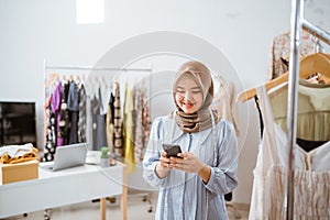 muslim woman small business owner at her shop selling through e commerce