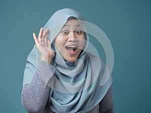 Muslim Woman Smiling While Doing Hearing Gesture