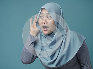 Muslim Woman Smiling While Doing Hearing Gesture