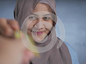 Muslim Woman Smiling When Receiving Credit Card