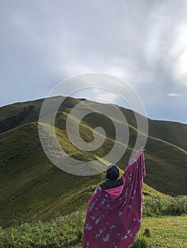 Muslim woman standing in front of Holbung hill, Samosir, Nort Sumatera. photo
