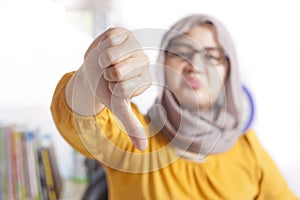 Muslim Woman Thumbs Down, Dissapointed Expression