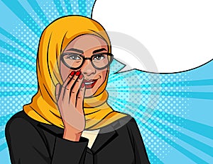 Muslim woman in a traditional scarf and glasses is whispering.