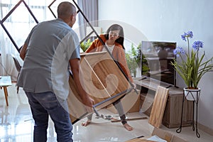 muslim woman try so hard to lift the new furniture