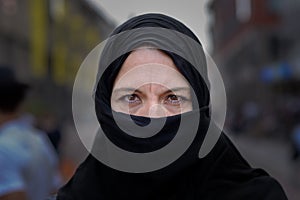 Muslim woman wearing a black hijab in town