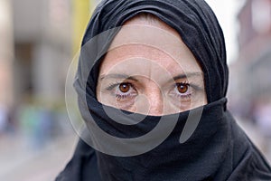 Muslim woman wearing a black hijab in town