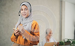 Muslim woman wearing headsets