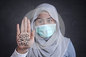 Muslim woman wearing mask to prevent coronavirus covid 19 pandemi